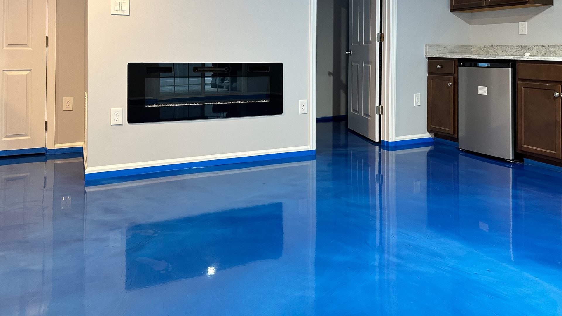 Basement with a glossy blue epoxy floor