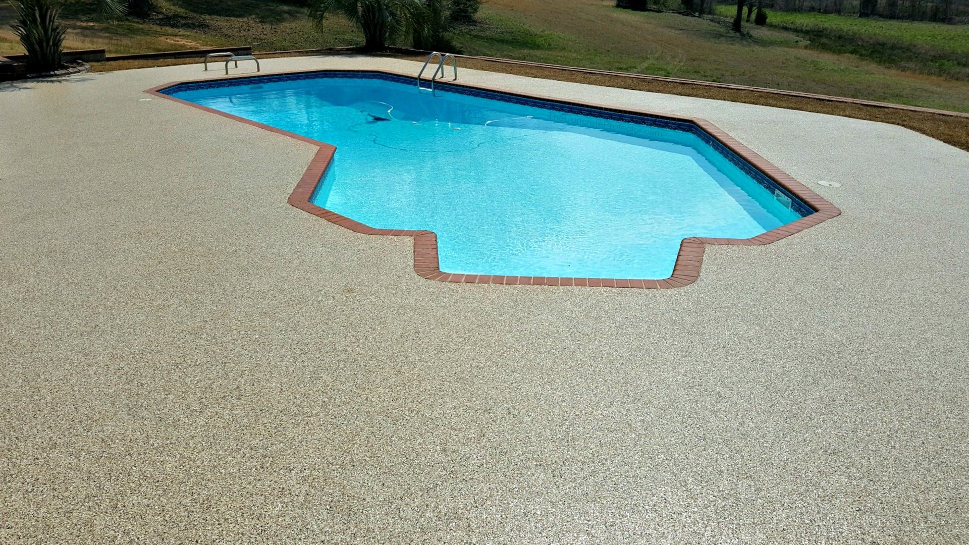 Outdoor pool surrounded by a textured deck coating